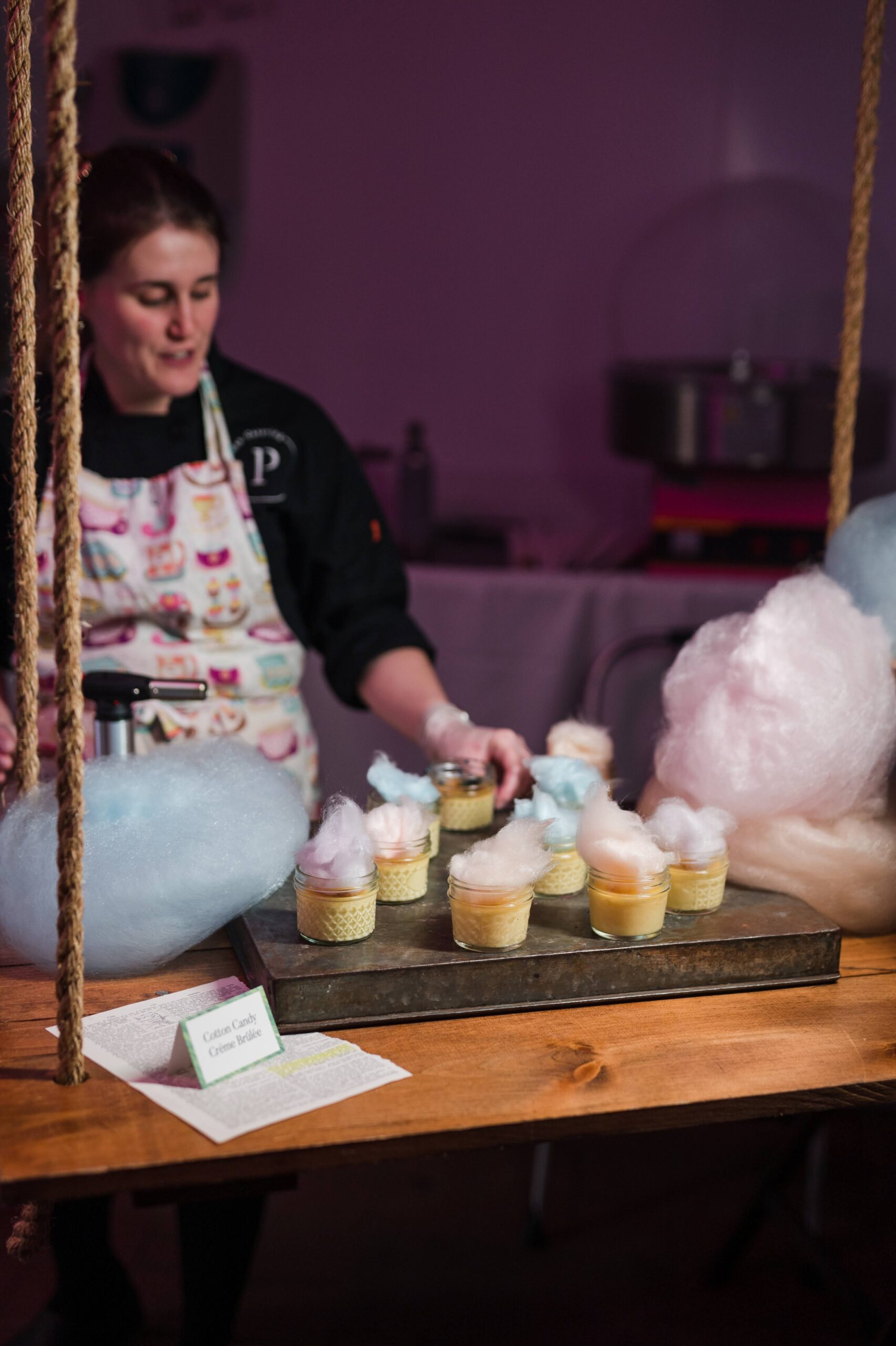 Cotton Candy Crème Brûlée Station at P is for Party A catering chef serves whimsical cotton candy crème brûlée desserts in glass jars at Partyman Catering’s “P is for Party” event.