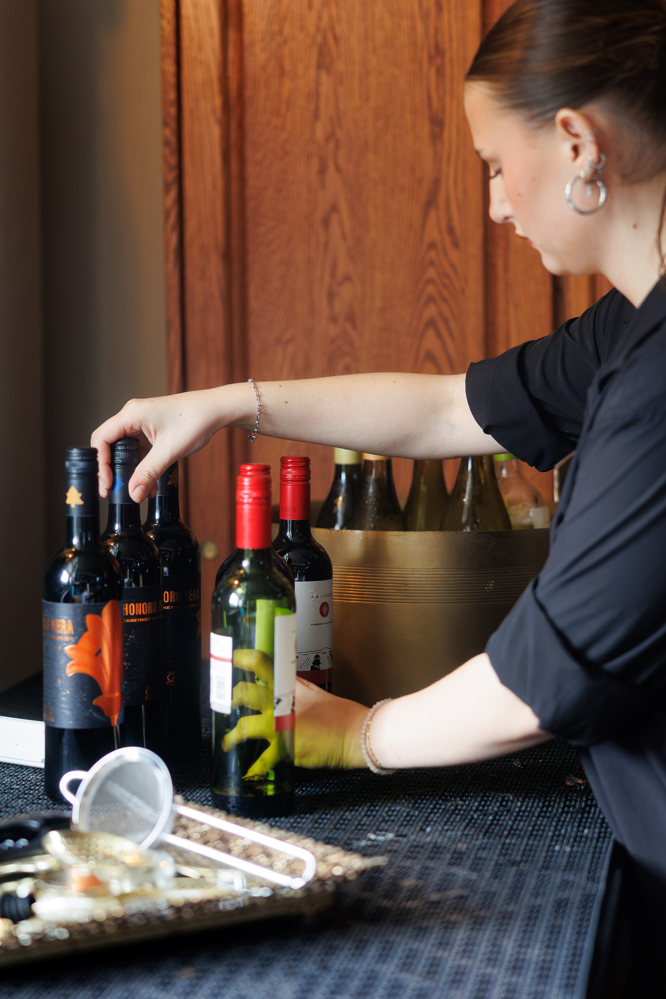 Partyman Catering Bartender Preparing Bar Service at The Historic German House Partyman Catering team member arranging wine bottles and preparing bar service before guests arrive at The Historic German House in Rochester, NY.