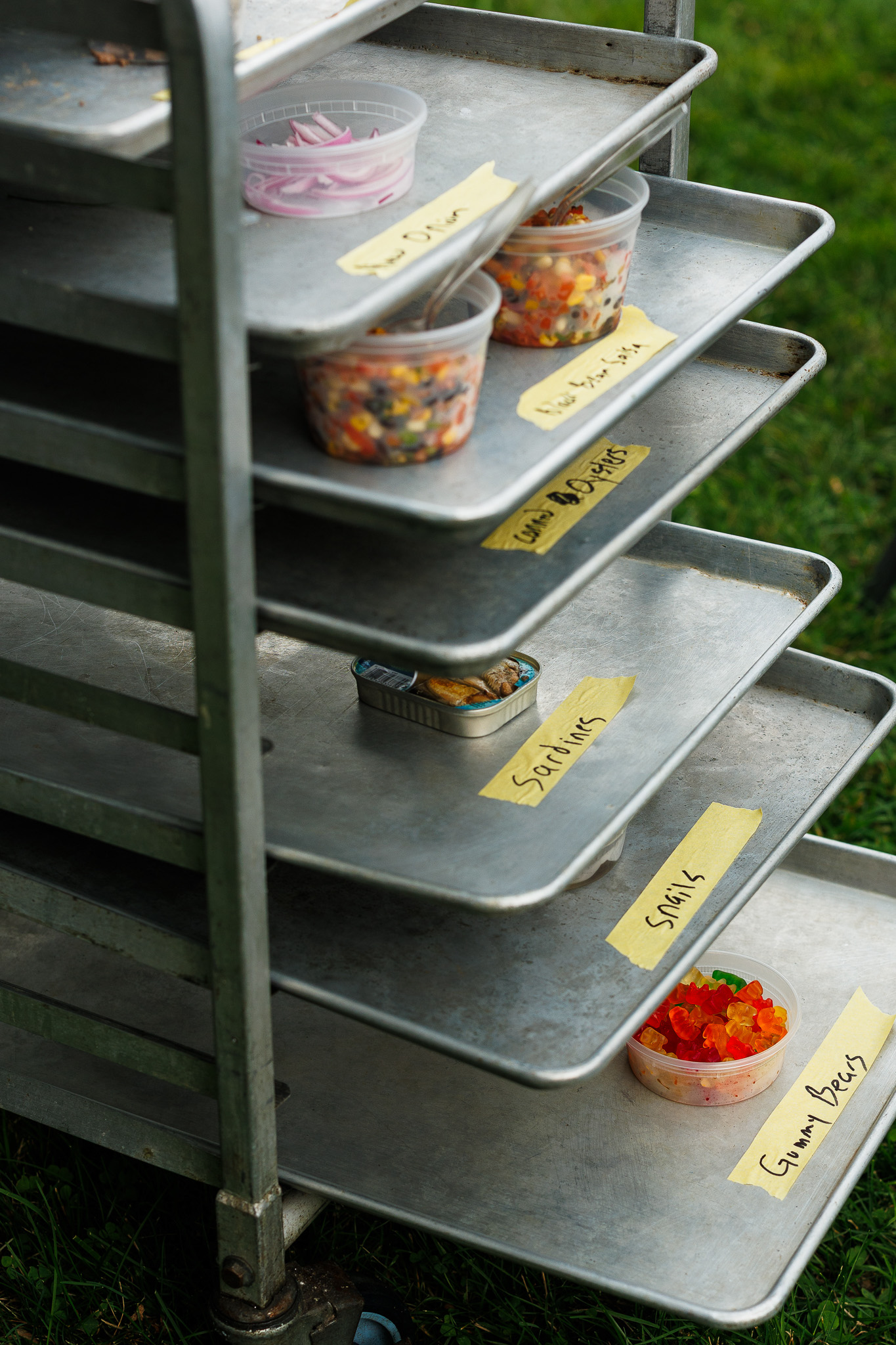 Grit & Chew Challenge | Funner Olympics 2026 Catering trays hold unusual labeled food ingredients for Grit & Chew, a food-based team challenge at Partyman’s 2026 Funner Olympics.