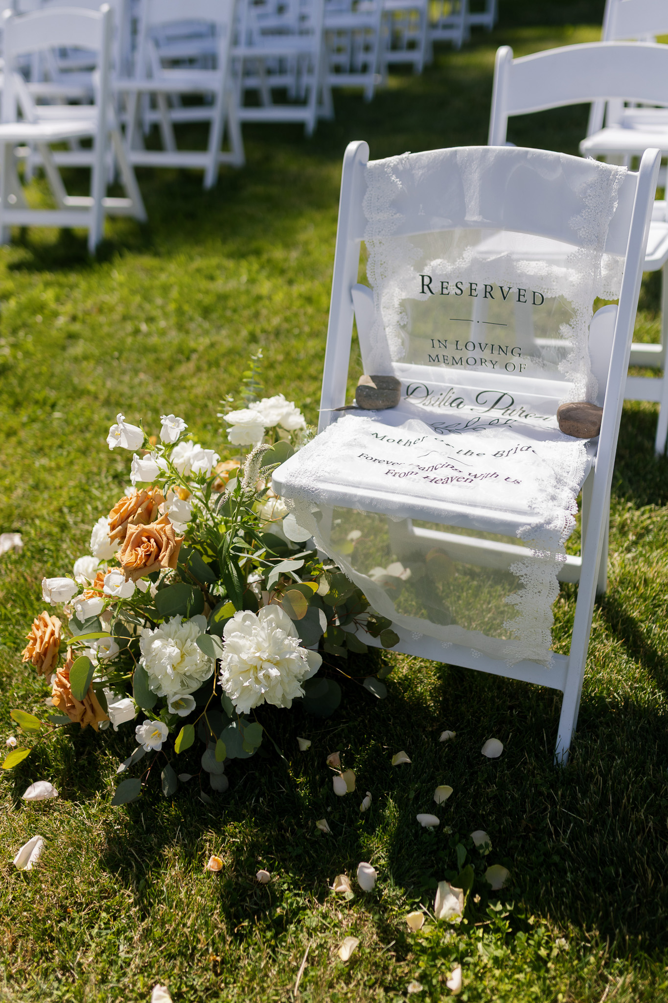Wedding Ceremony Memorial Chair Reserved wedding ceremony chair decorated with lace, flowers and a memorial sign honoring a loved one.